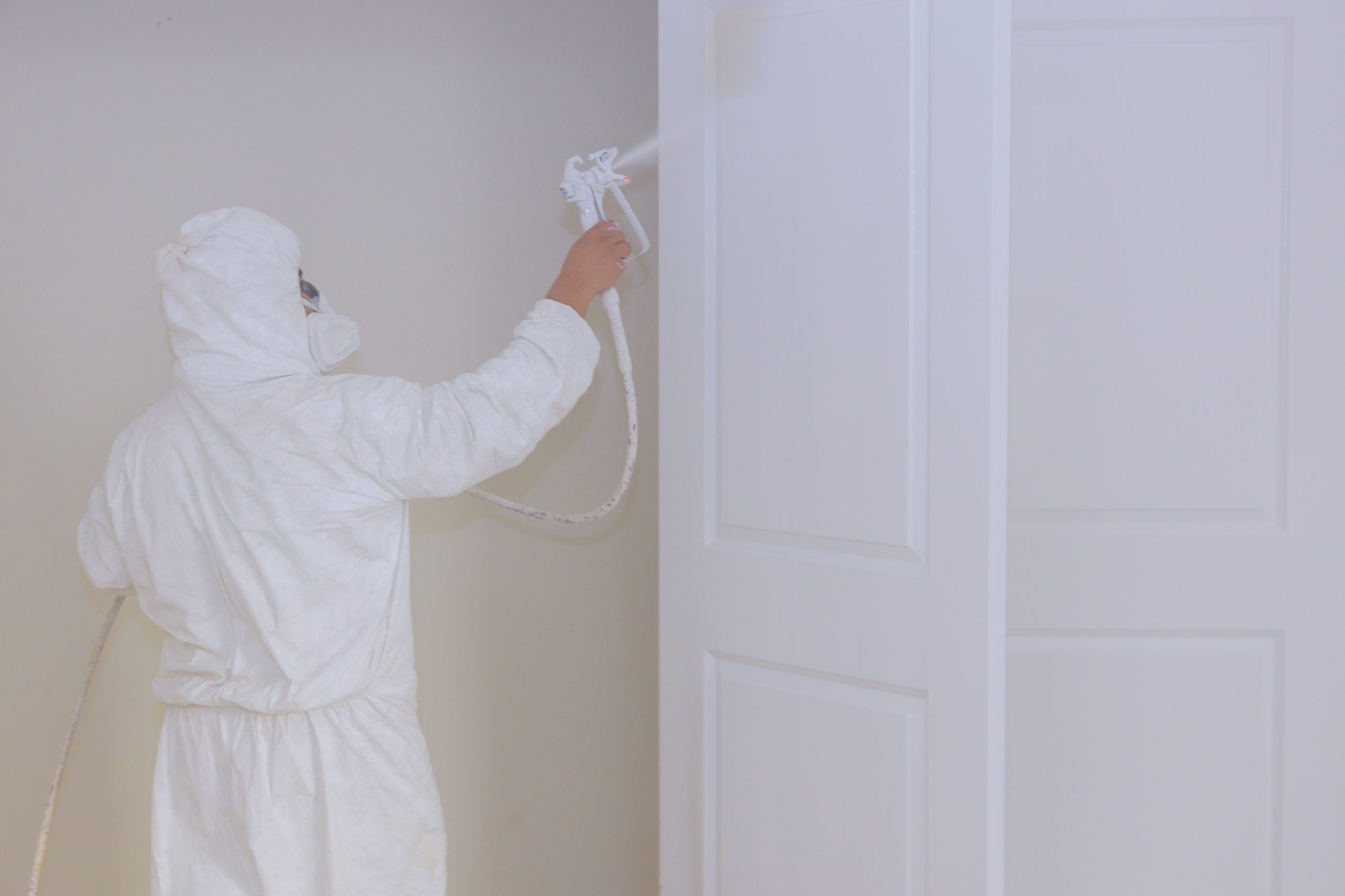 master painting wood doors with spray gun